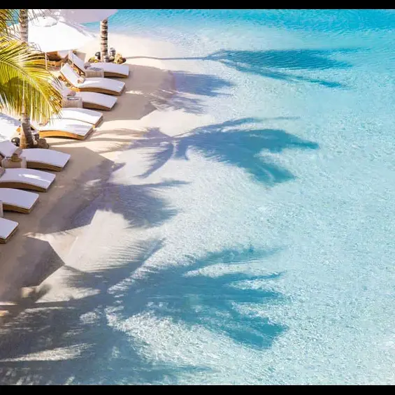 Beach chairs line large commercial sand pool