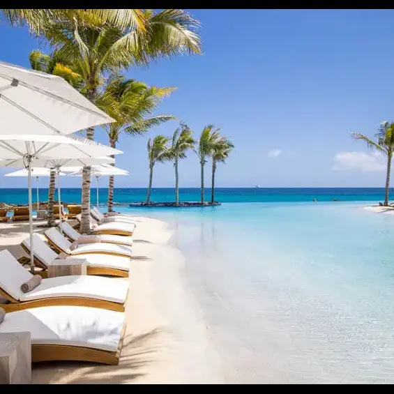 Beach chairs line large commercial sand pool