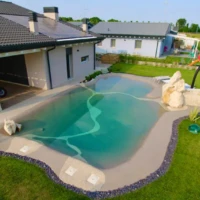 small sand pool against house