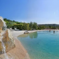 two bathers in sand pool with two stones